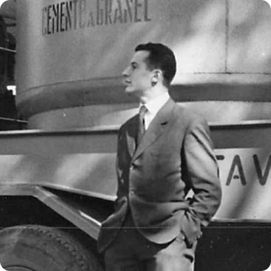 Blaise Rastoin, founder of Transitube International, standing next to a bulk powder transport truck in Marseille in the early days of the company