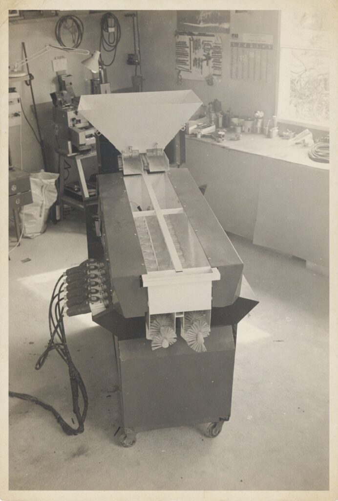 Transitube International vintage archive photos showing early powder transfer equipment including hoppers, agitators and flexible screw conveyor systems